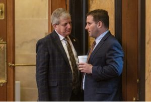 Rep. Donnie Scoggin, left, and Rep. Trey Lamar have a conversation during legislative session at the Capitol in Jackson, Miss., Thursday, March 23, 2023. Credit: Eric Shelton/Mississippi Today