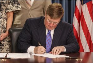 Gov. Tate Reeves signs House Bill 1671, House Bill 510 and Senate Bill 2696 into law at the Walter Sillers Building in Jackson, Miss., Wednesday, April 19, 2023. Credit: Eric Shelton/Mississippi Today