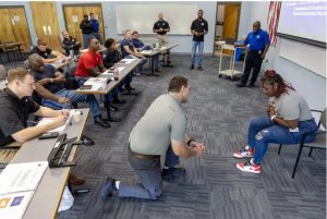 Mississippi Highway Patrol Trooper Sy Holley, center, and Latesha Wells, case manager with Hinds Behavioral's Mobile Crisis Response Team, right, participate in a psychiatric call simulation during a training session at the Mississippi Law Enforcement Officers Training Academy in Pearl, Miss., Friday, July 30, 2023. Credit: Eric Shelton/Mississippi Today