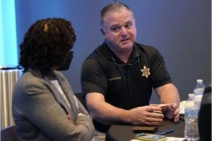 Rankin County Sheriff Bryan Bailey, right, speaks to an attendee at an employer engagement forum in Jackson, Miss., Nov. 4, 2021. Bailey announced Tuesday, June 27, 2023, that an unspecified number of Rankin County deputies had been fired because of their involvement in a Jan. 24, encounter in which two Black men said six white deputies handcuffed and beat them and one of the Black men was shot in the mouth. Credit: Photo/Rogelio V. Solis, File)