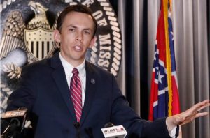 State Auditor Shad White speaks of the contents of a 104-page audit of the Mississippi Department of Human Services released Monday, May 4, 2020, that shows how welfare grant funds flowed from DHS into two nonprofits, which then frequently spent the cash in inappropriate or questionable ways, at a news briefing in Jackson, Miss. More than $94 million in welfare money spending was "questioned" by auditors. Some funds were used to buy luxury cars, sponsor a college baseball tournament and hire family members. (AP Photo/Rogelio V. Solis)