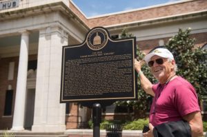 Jimmy Buffett, pictured at the bronze plaque honoring Buffett and Fingers Taylor in front the The Hub at Southern Miss. Credit: USM Communications
